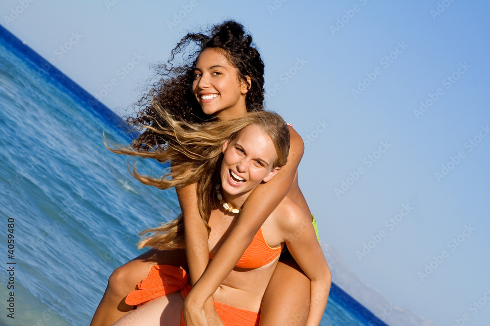 Wall mural piggyback fun on summer vacation, happy smiling teens