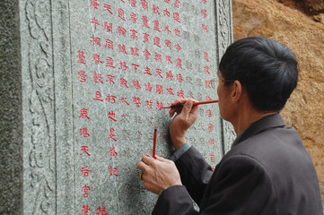chinese scribe writing with brush