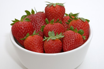 close up of strawberries in bowl with isolated background