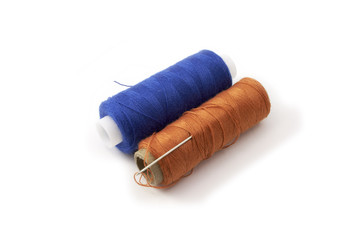 Blue and orange spools of thread