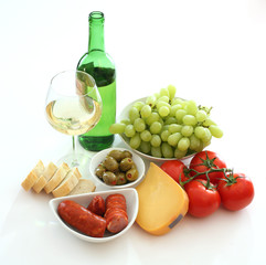 Wine, grapes, bread, tomato, sausage, olives and cheese