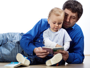 A father reading a book to son