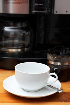 Close-up of coffee cup and coffee machine