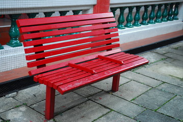 red bench in the gardens
