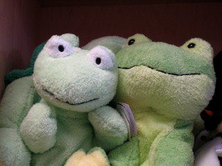 Two green animal stuffed toys