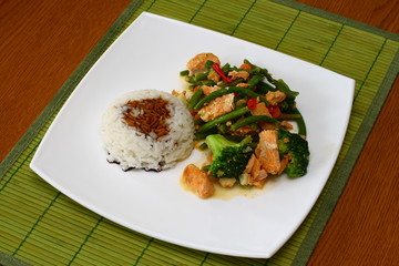 Hot thai food - salmon with rice and vegetables