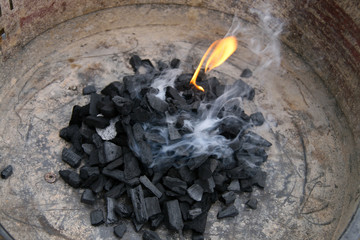 barbecue started, coal, flame and smoke