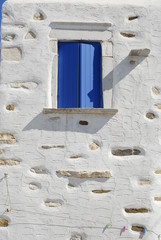 blue window in old house in greek island, greece