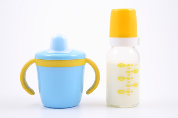 bottle of milk and baby cup