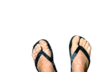 Woman's feet with a pair of flip flops cooling in water