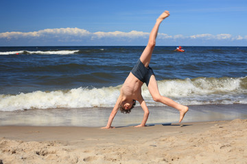 Boy jumping on beach