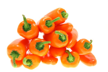 stacked orange bell pointed peppers