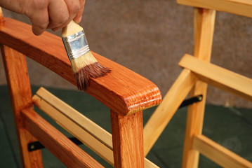 painting a chair with a brush