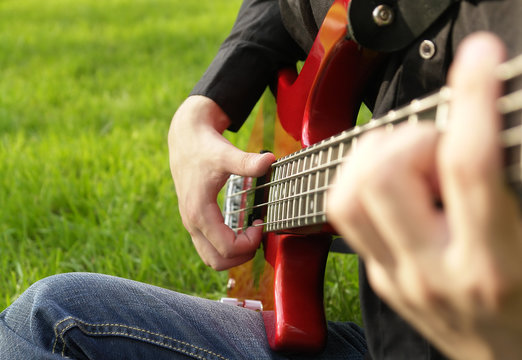 Teenage Boy Playing The Bass Guitar