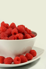 raspberries on white bowl