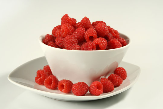 raspberries on white bowl