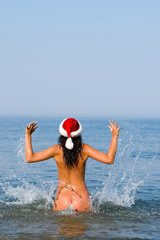 young sexy santa girl in the sea