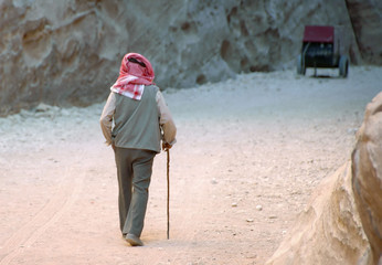 Back of an Elderly Arab Man Walking Down a Road