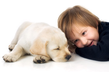 Child next to puppy