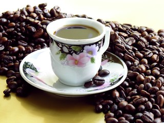 cup of black coffee and coffee roasted beans