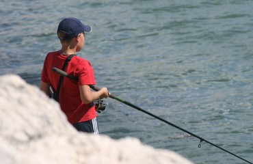 boy fishing in the sea