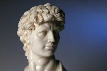 Fototapeta na wymiar Replica of David over a blue background