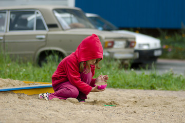 Little girl playing with sand