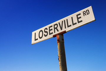 Sign against blue sky