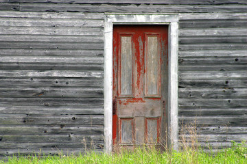 Red old door on grey old wood wall