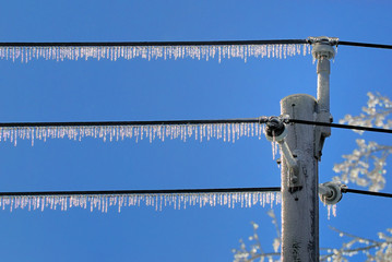 Icicles hanging from power lines after an ice storm