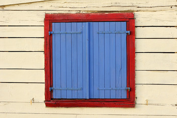 Obraz premium painted window shutters on beach hut