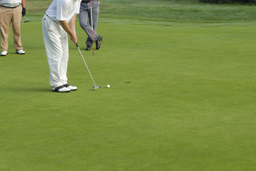 Putting on golf green