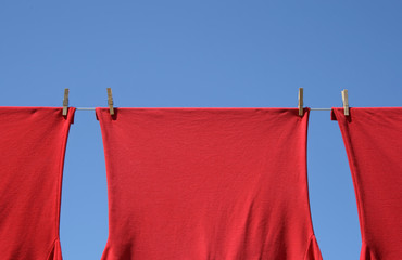 Red t-shirts on a clothes-line