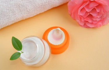 Bathroom still-life - Moisturizing face cream with towel