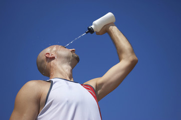 male athlete pouring water