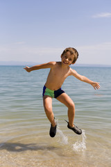 Child jump on the beach