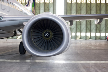 Jet engine at aircraft in the hangar, back view