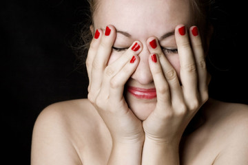 Smiling woman with hands on head