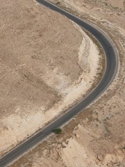 Birdseye view on a curvy, asphalt, desert highway