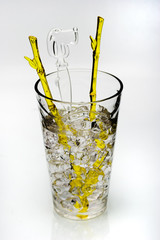 cold drink with ice and yellow stirring rod isolated 