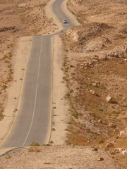 Desert highway with a car approaching, King highway, Jordan