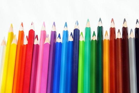 Assortment of colored pencils with shadow on white background 