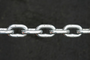 Metal chain on the black background