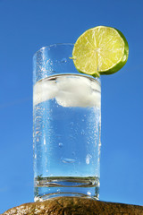 Cold glass of water against a blue sky