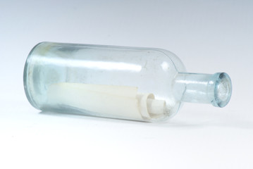 Paper scroll with message in the bottle