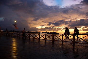 Fototapeta na wymiar sunset at kota kinabalu sea side / deck / jetty