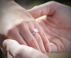 A newly engaged couple showing off the engagement ring