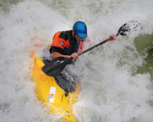 Man Paddling his Kayak on Whitewater Rapids