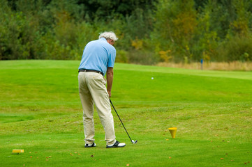 senior man playing golf