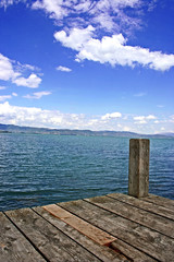 view of a lake from an old wooden jetty